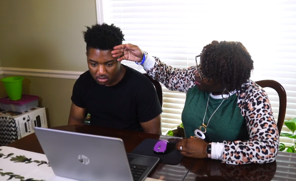 Teenage boy and grandmother having telehealth visit